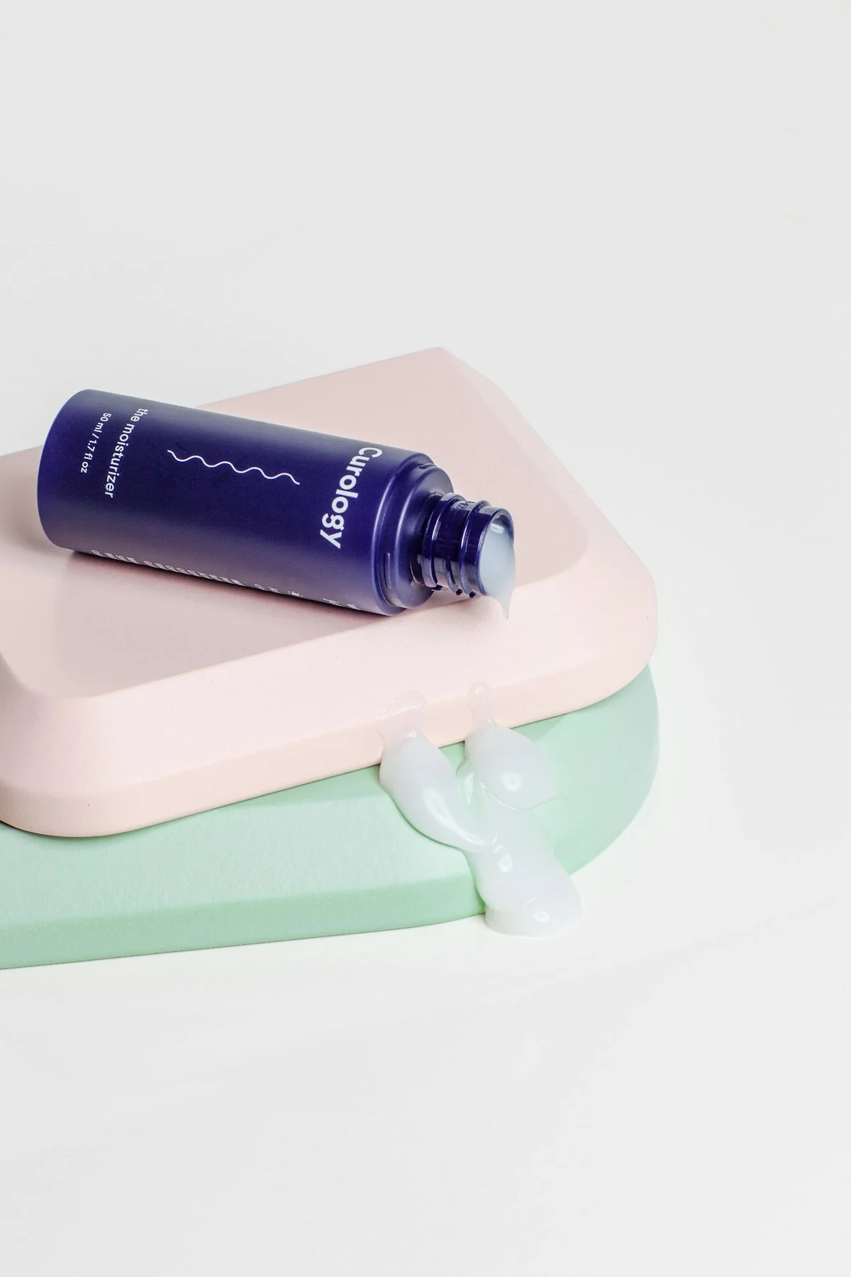 Moisturizer product arranged on pastel display blocks